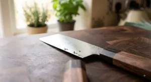 Close-up detail of the straight stainless steel blade and flat profile of the best nakiri knife for effortless vegetable preparation.